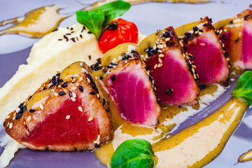 Wall Mural - Grilled Tuna steak in sesame seeds and fennel puree on a plate.