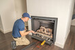 © spatesphoto - Technician working on a gas fireplace