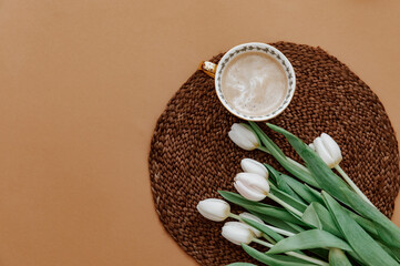 Canvas Print - Cup of coffee with bouquet of white tulips.Valentines, Mothers, Womens Day morning concept. Top view. Copy space, flat lay .