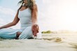 © Davide Angelini - Senior woman in lotus pose sitting on the sand - Yoga at beach - Calm and meditation concept
