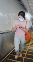 Wall Mural - woman standing on escalator