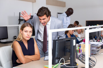 Wall Mural - Male angry boss blaming female office worker in office