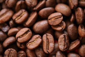 Coffee beans background. Roasted coffee close-up.Texture of coffee beans.Arabica and Robusta coffee variety.Traditional morning drink