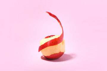 Peeled red apple on color background