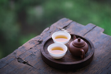 still life with tea. Two cups of tea and a teapot on the old wooden board table. Tea table by the window.