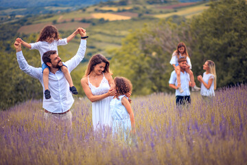 Wall Mural - Large group of people in lavender field. Focus is on foreground.