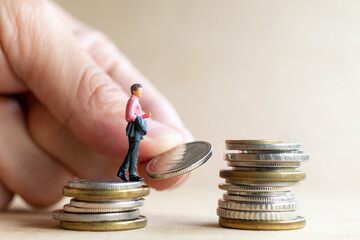 Miniature people businessman with coins. Business Growth concept