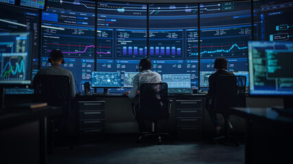 Wall Mural - Professional IT Technical Support Specialists and Software Programmer Working on Computers in Monitoring Control Room with Digital Screens with Server Data, Blockchain Network and Surveillance Maps. 