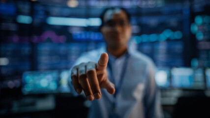 Aufkleber - Shot with Focus on Finger of a Professional IT Technical Support Specialist or Software Developer Pushing an Augmented Reality Display in Control Room Full of Computers. Shot iwth Blurred Background.
