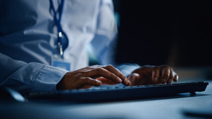 Fototapete - Close Up of a Professional Office Specialist Working on Desktop Computer in Modern Technological Monitoring Control Room with Digital Screens. Manager Typing on keyboard.