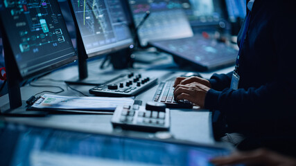 Fototapete - Close Up of a Professional Office Specialist Working on Desktop Computer in Modern Technological Monitoring Control Room with Digital Screens. Manager Typing on keyboard and Using Mouse.