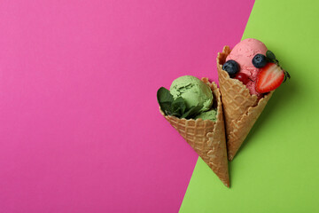 Cones of fruit ice cream on two tone background