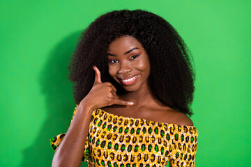 Sticker - Photo of cheerful nice brown hair lady show call me wear yellow shirt isolated on green color background