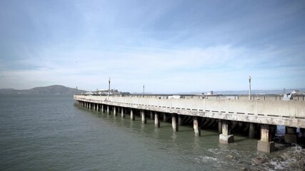 Wall Mural - Panorama view of Alcatraz Island and people walking and running on the pier