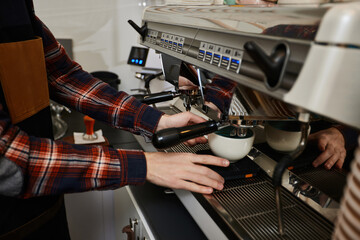 Barista using a coffee machine to make coffee