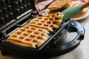 waffles are baked waffle iron machine. close up