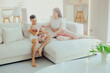 © Mirrorstudio - Father, mother and little son are relaxing on sofa in living room