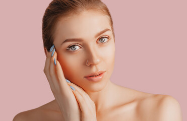 Wall Mural - beautiful sensual young girl with clean skin on a pink background with a mockup. topless woman. the 