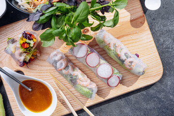 Wall Mural - fresh springrolls with vegetables and shrimps. a healthy dish of rice paper and fresh organic vegetables