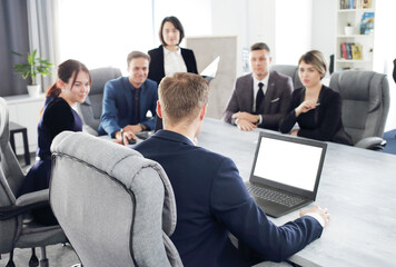 Wall Mural - Group of young business people meeting in the office having fun together discussing an idea