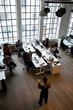 © Maskot - High angle view of businesswoman giving presentation to colleagues during meeting at creative office