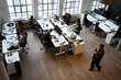 © Maskot - High angle view of male and female professionals working at desk in office