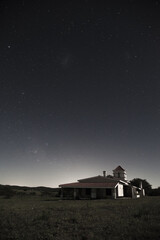 Poster - Vertical shot of a big house against a starry sky background