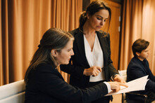 Businesswoman Brainstorming Storming Over Legal Document With Female Lawyer In Office