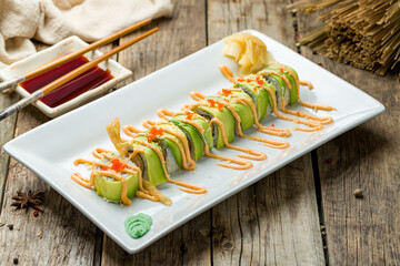 Wall Mural - Sushi roll with shrimp and avocado on old wooden table