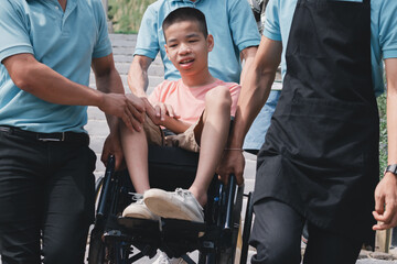 Wall Mural - Disabled child smile on wheelchair with service personnel help lift down the stairs, Encounter problems Some places do not have wheelchair ramps,necessary to seek help from kind people in society.