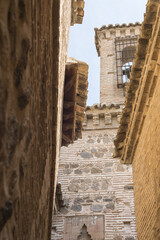 Sticker - Vertical shot of buildings with a narrow pathway in Toledo Spain