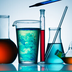 Wall Mural - different laboratory glassware with color liquid and with reflection