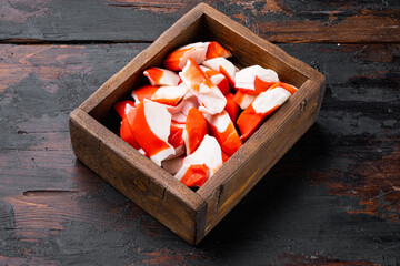 Wall Mural - Fresh Crab meat surimi with blue swimming crab, in wooden box, on dark wooden background