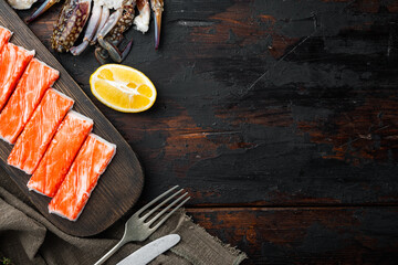 Wall Mural - Asian snack surimi, on dark wooden background, top view flat lay  , with copyspace  and space for text