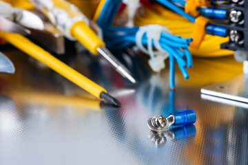 Wall Mural - Set of electrical tools and equipment on a metal background, closeup