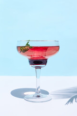 Wall Mural - Fresh summer strawberry cocktail or mocktail on blue patel background. Creative drink beverage on sunlight with shadows