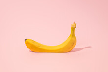 Cutted Banana On A Pink Background. MInimal Creativ Summer Concept.