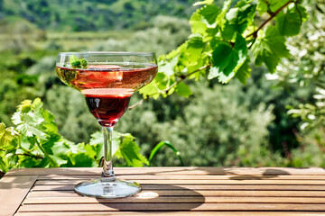 Wall Mural - Fresh summer strawberry cocktail or mocktail on the table in garden.Creative drink beverage on sunlight with shadows