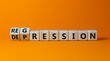 Depression or regression symbol. Turned cubes and changed the word 'depression' to 'regression'. Beautiful orange background. Psychological, depression or regression concept. Copy space.