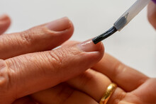 Manicure Paints Nails With Enamel