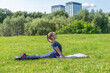 © Андрей Рыков - Portrait of slim caucasian teenage girl doing yoga in summer city park. Cobra pose (Bhujangasana). Healthy lifestyle. Outdoor sport theme.