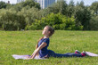 © Андрей Рыков - Portrait of slim caucasian teenage girl doing yoga in summer city park. Cobra pose (Bhujangasana). Healthy lifestyle. Outdoor sport theme.