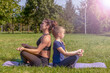 © Андрей Рыков - Photography of caucasian teenage girl and muscular woman doing yoga in summer city park together. Mother and daughter. Lotus position (Padmasana). Healthy lifestyle. Outdoor family sport theme.