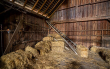 An Old Orchard Ladder And Several Bales Of Hay Inside An Old Abandoned Barn Near Jefferson Oregon.