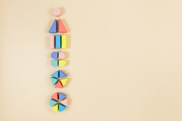 Wall Mural - Multicolored wooden fractions on wooden table. Trendy puzzle toys. Geometric shapes. Back to school. Educational toys for kindergarten, preschool or daycare. Close up.