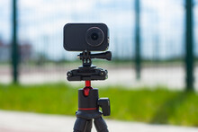 Compact Action Camera On A Flexible Tripod. Outdoor Travel Equipment.