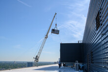 Large Commercial Chiller Air Conditioner Being Lifted Onto Roof Of High Rise Office Building.