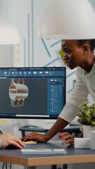 industrial engineer and african project manager working on 3d construction metalic components in cad