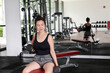 © oqba - beautiful attractive middle age southeast asian woman arm shoulder dumbbell exercise gymnasium healthy lifestyle look forward
