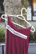 A Red Dress With Text "End The Violence" Is Hanging On The Tree Near The Law Courts . Art Memorial To Honour Missing And Murdered Indigenous Women In US And Canada